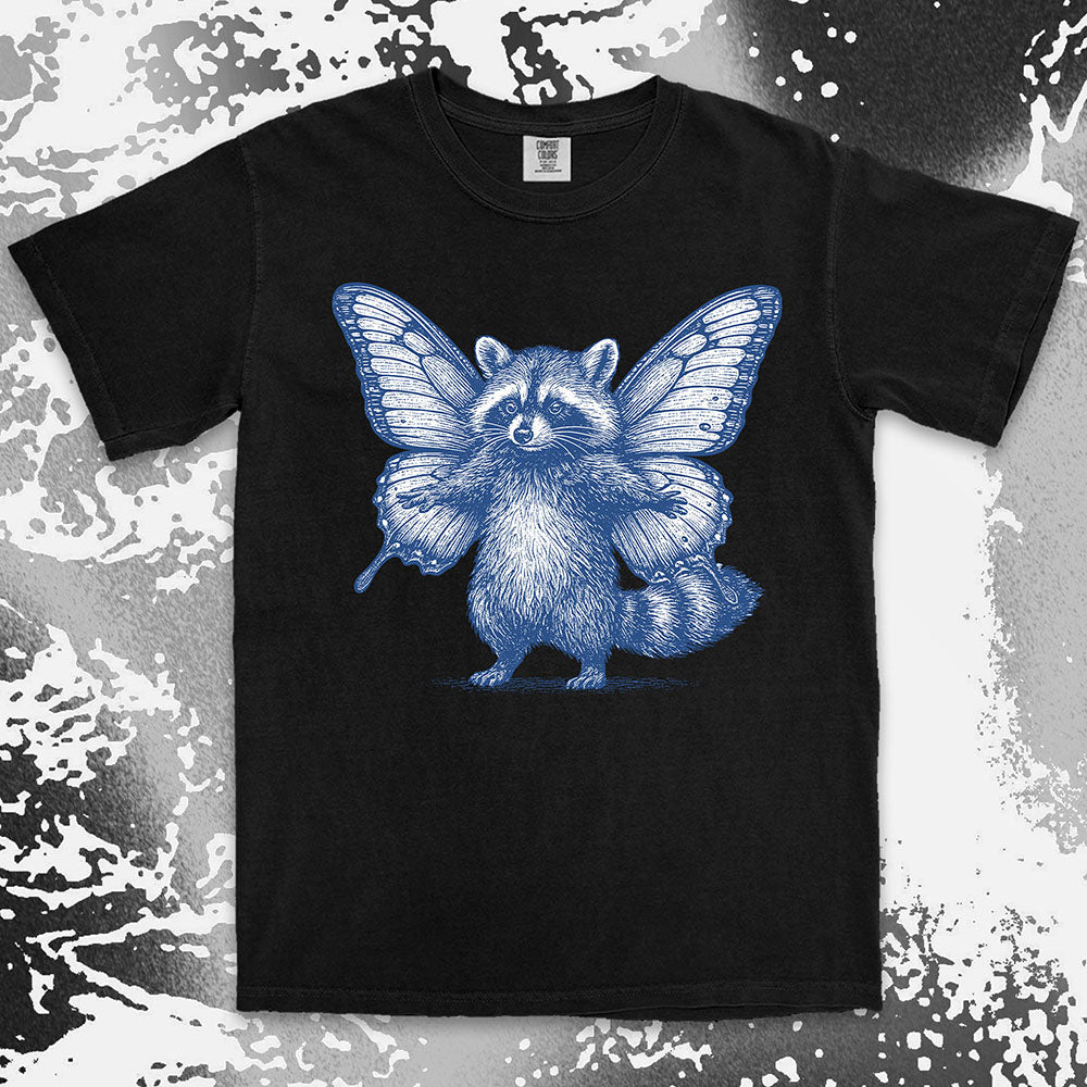 Comfort Color t-shirt with raccoon illustration featuring big butterfly wings in a magical fairy style.