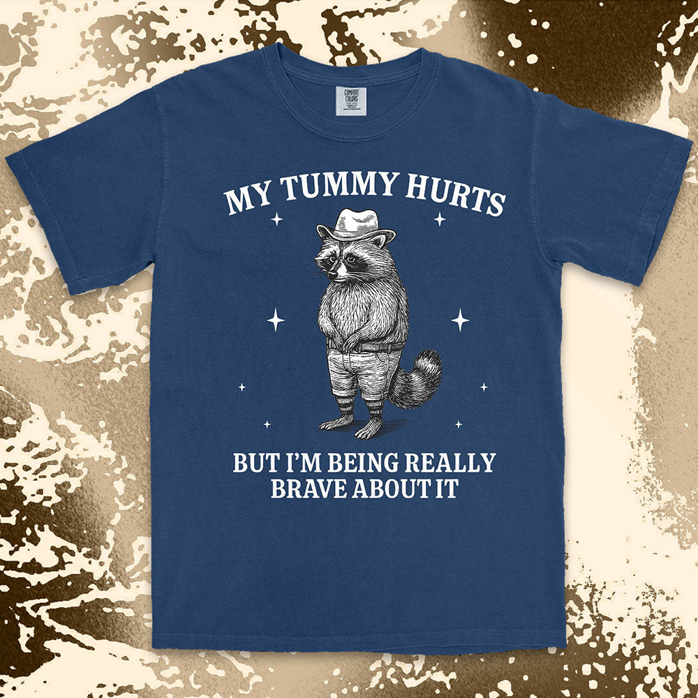 Funny raccoon shirt with “My Tummy Hurts But I’m Being Really Brave About It” quote, cowboy hat animal design