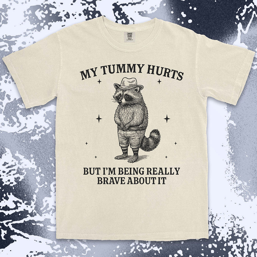 Funny raccoon shirt with “My Tummy Hurts But I’m Being Really Brave About It” quote, cowboy hat animal design