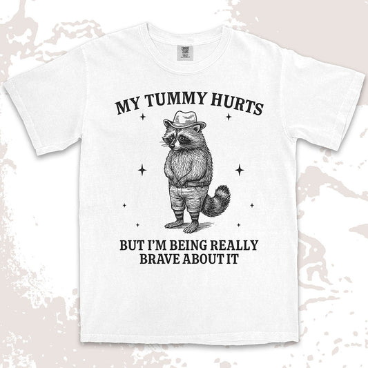 Funny raccoon shirt with “My Tummy Hurts But I’m Being Really Brave About It” quote, cowboy hat animal design