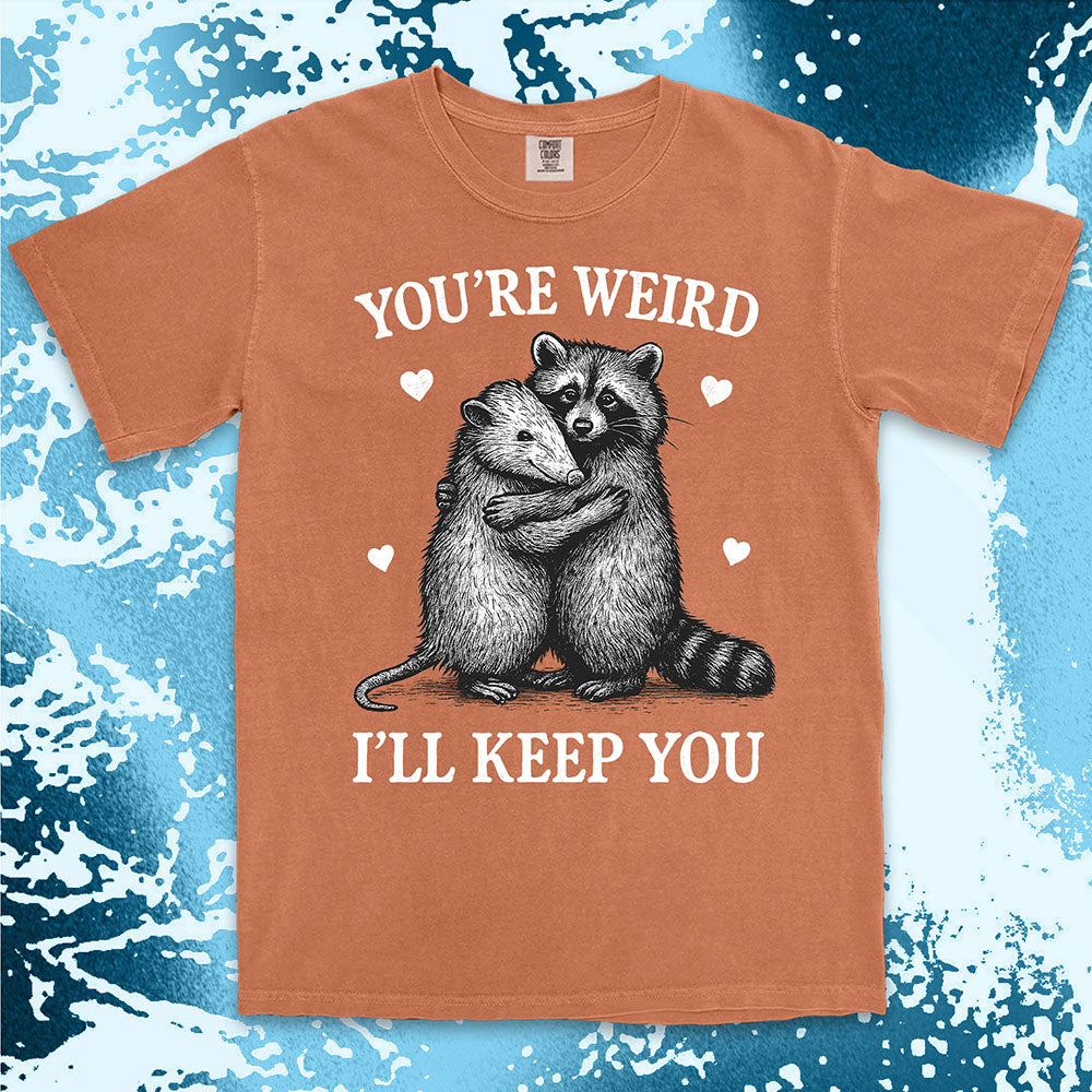 Funny raccoon possum hugging graphic with text You’re Weird I’ll Keep You comfort color t shirt