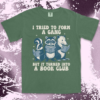Comfort Color t-shirt with raccoon, skunk, and possum reading books and quote “I tried to form a gang but it turned into a book club.”