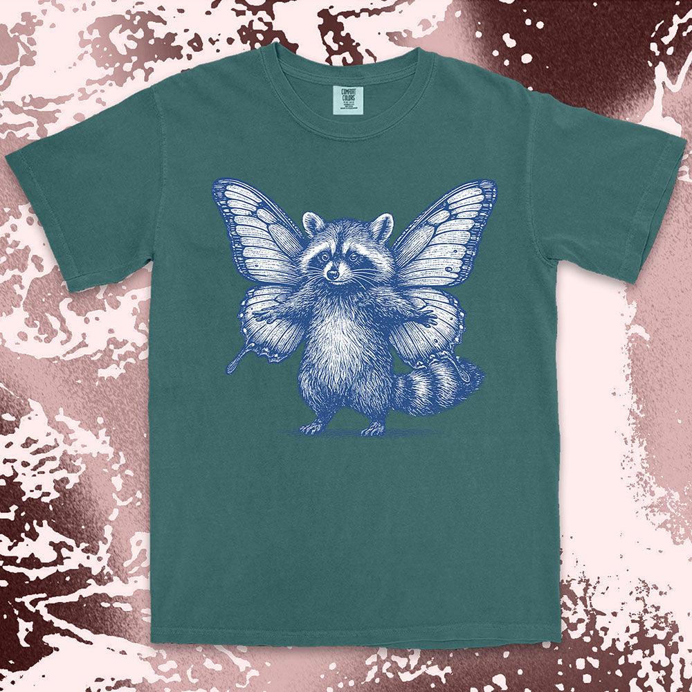Comfort Color t-shirt with raccoon illustration featuring big butterfly wings in a magical fairy style.
