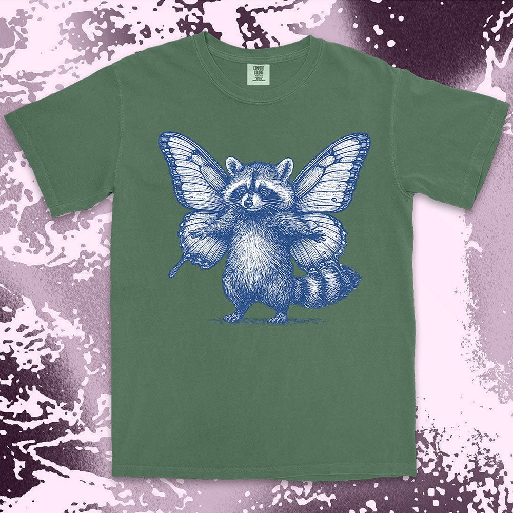 Comfort Color t-shirt with raccoon illustration featuring big butterfly wings in a magical fairy style.