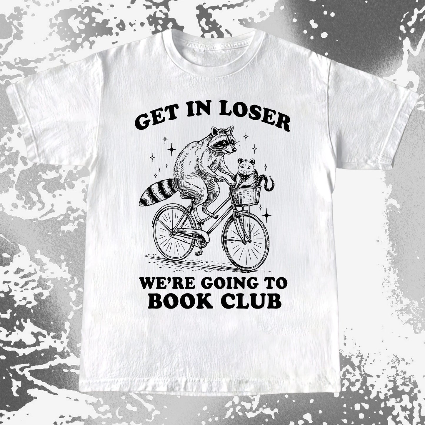 Raccoon riding a bicycle with an opossum in a basket and the text “Get In Loser, We’re Going to Book Club” on a humorous T-shirt design.