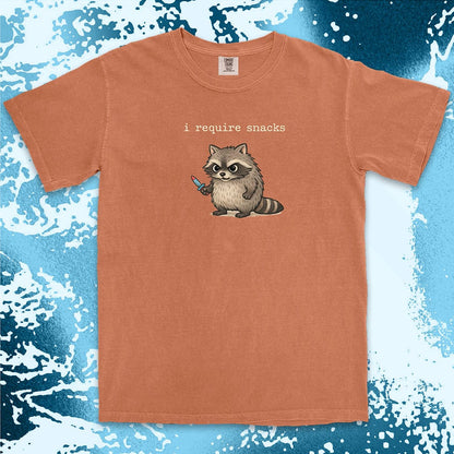 Cute raccoon shirt with ÒI require snacksÓ quote, chubby raccoon holding a small knife. Comfort Color t-shirt.