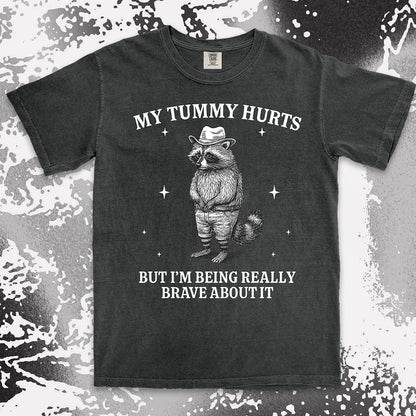 Funny raccoon shirt with “My Tummy Hurts But I’m Being Really Brave About It” quote, cowboy hat animal design