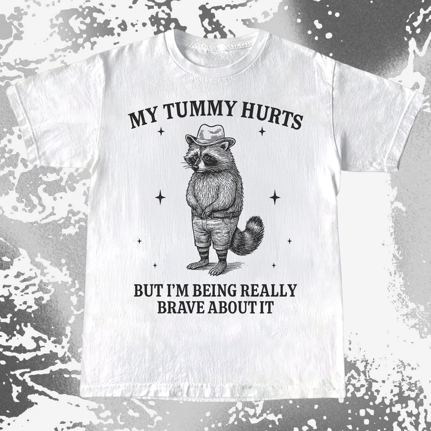 Illustration of a raccoon in overalls and a hat with the text My Tummy Hurts But Im Being Really Brave About It on a humorous T-shirt design.