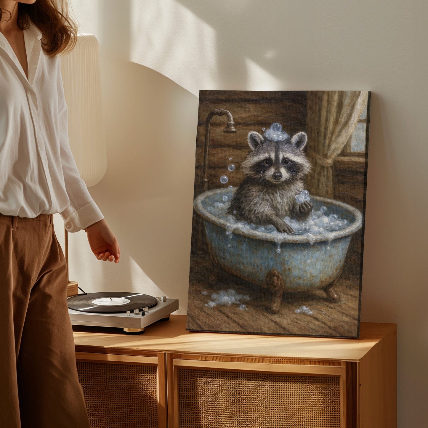 Whimsical raccoon bath canvas wall art featuring a raccoon in a vintage tub with bubbles inside a rustic wooden cabin