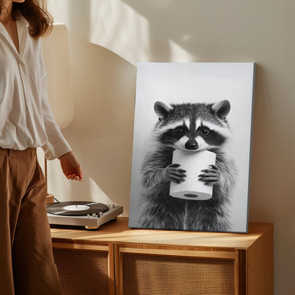Funny raccoon canvas wall art featuring a raccoon holding a toilet paper roll in black and white minimalist style