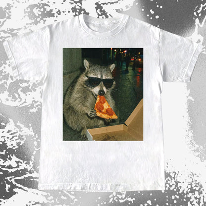 Raccoon wearing sunglasses eating a slice of pepperoni pizza at night.