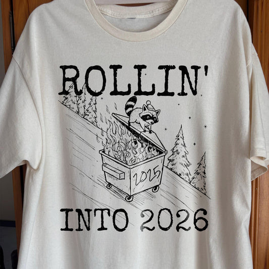 Rollin’ Into 2026 Raccoon Dumpster Fire Line Art Shirt