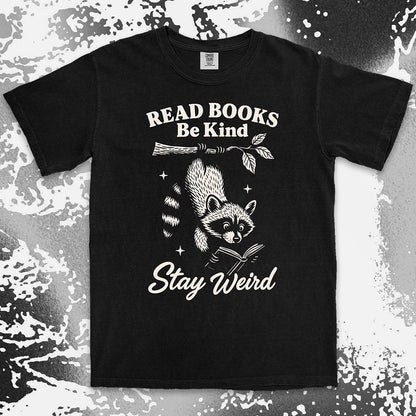 Comfort Color t-shirt with raccoon hanging from a branch reading a book and quote ÒRead books be kind stay weirdÓ printed in vintage style.