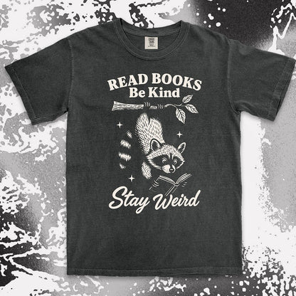 Comfort Color t-shirt with raccoon hanging from a branch reading a book and quote ÒRead books be kind stay weirdÓ printed in vintage style.