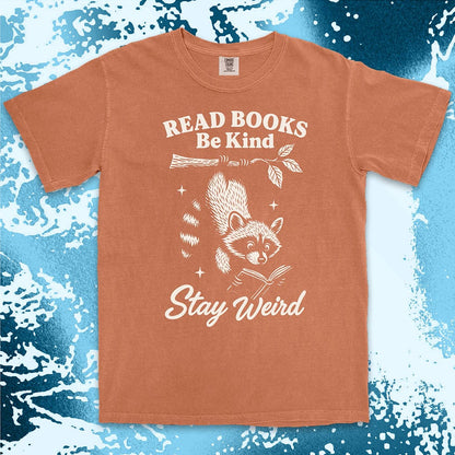 Comfort Color t-shirt with raccoon hanging from a branch reading a book and quote ÒRead books be kind stay weirdÓ printed in vintage style.